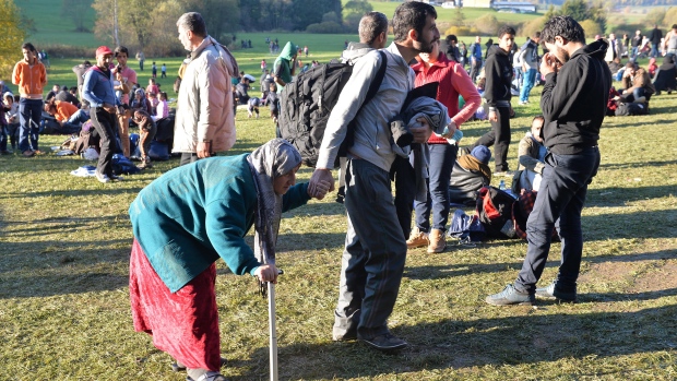 Migrants arrive at the border between Austria and Germany near Kollerschlag Austria Wednesday Oct. 28 2015. Austria said on Wednesday that will erect a fence on the border to stem the flow of migrants