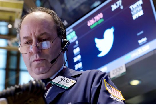 A trader works by the post where Twitter is traded on the floor of the New York Stock Exchange