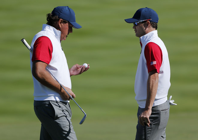 United States Phil Mickelson left and teammate Zach Johnson chat on the second hole during their four ball match at the Presidents Cup golf tournament at the Jack Nicklaus Golf Club Korea in Incheon South Korea Friday Oct. 9 2015.(AP