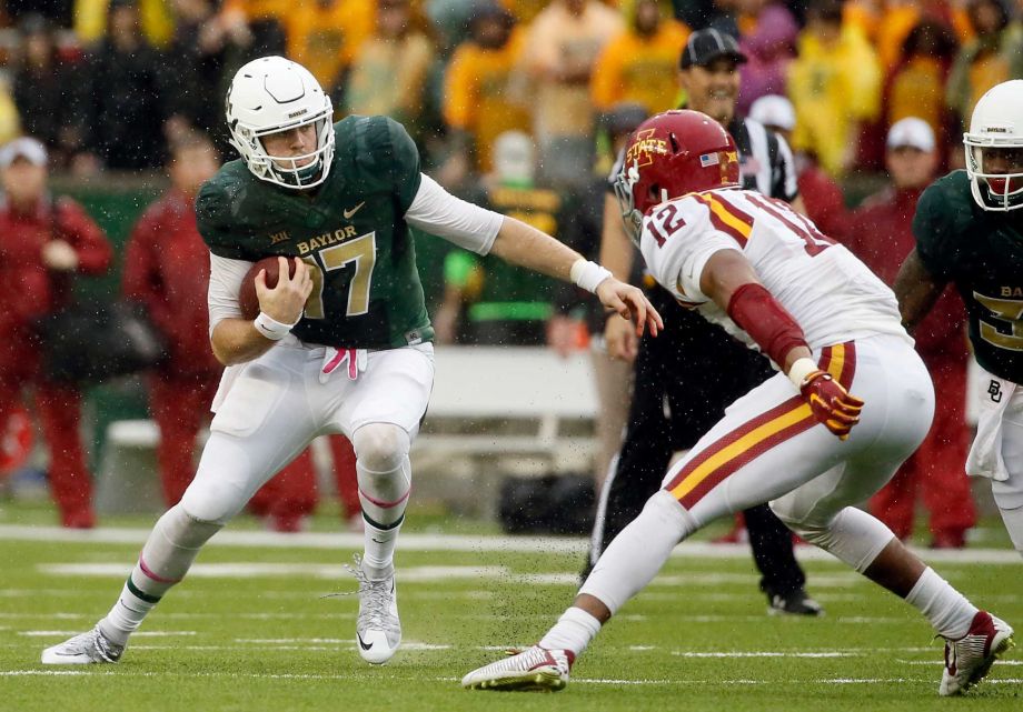 Baylor quarterback Seth Russell scrambles out of the pocket as Iowa State linebacker Jarnor Jones pursues in the first half of an NCAA college football game Saturday Oct. 24 2015 in Waco Texas