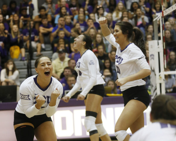 Alexia Heist Regan Mc Guire and Sarita Mikals celebrate during TCUs five-set battle with Baylor on Wednesday. The Frogs edged past the Bears to win the fifth set 15-10