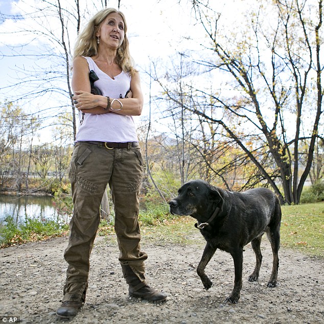 Kate Cholewa, 53 of Paradise Valley was walking along the Yellowstone River with her 12-year-old dog Carmen when a bear attacked her on Monday. Her black Labrador mix started barking and the bear retreated allowing Cholewa to flee