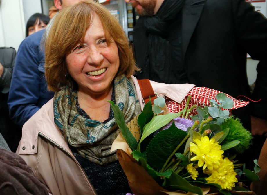 Belarusian journalist and writer Svetlana Alexievich who has been named the 2015 Nobel literature winner holds flowers as she leaves a news conference in Minsk Belarus Thursday Oct. 8 2015. Belarusian writer Svetlana Alexievich won the Nobel Prize