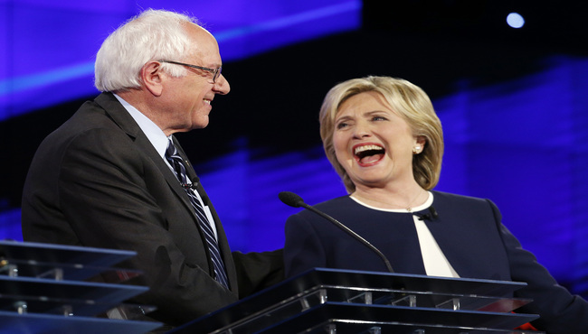 Sen. Bernie Sanders of Vermont, left and Hillary Rodham Clinton laugh during the CNN Democratic presidential debate Tuesday Oct. 13 2015 in Las Vegas