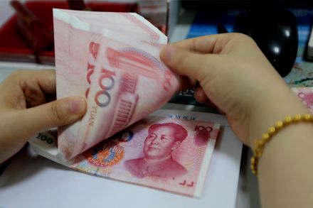 China's yuan firms on midpoint fix, pre-holiday local currency demand