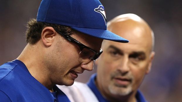 Blue Jays relief pitcher Brett Cecil left seen here walking off the field at the Rogers Centre with trainer George Poulis has seen his season come to an end by a torn left calf muscle. He injured himself while tagging out the Rangers&#39 Mike Napoli