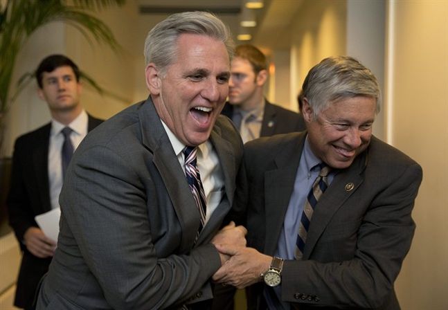 House Majority Leader Kevin Mc Carthy of Calif. left and Rep. Fred Upton R-Mich. laugh together as they walk from a meeting on Capitol Hill in Washington Monday Oct. 26 2015. Speaker John Boehner is pressing ahead with one last deal as he heads for