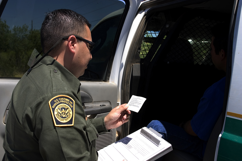 Border Patrol agents reads the Miranda rights to a Mexican national arrested for transporting drugs