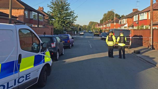 Police at Gillingham Street Salford where a youngster and his mother suffered leg wounds in the doorway of their home last night after being caught in crossfire