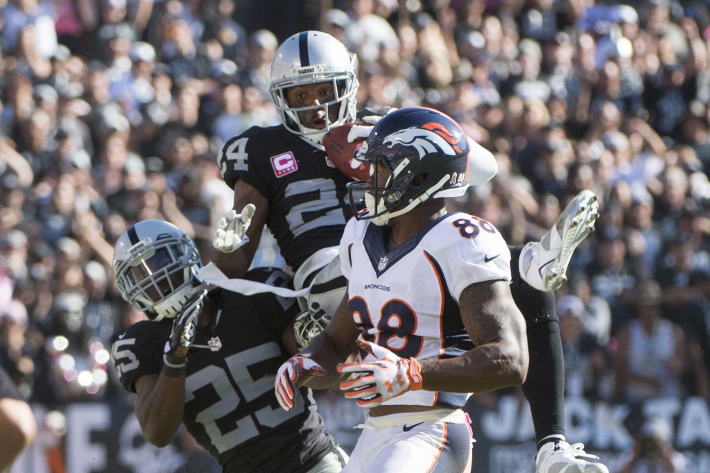 Oakland CA USA Oakland Raiders free safety Charles Woodson intercepts the football intended for Denver Broncos wide receiver Demaryius Thomas during the third quarter