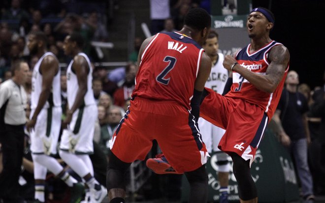 Bradley Beal right reacts with teammate John Wall left after making a three-point basket against the Milwaukee Bucks during the second half