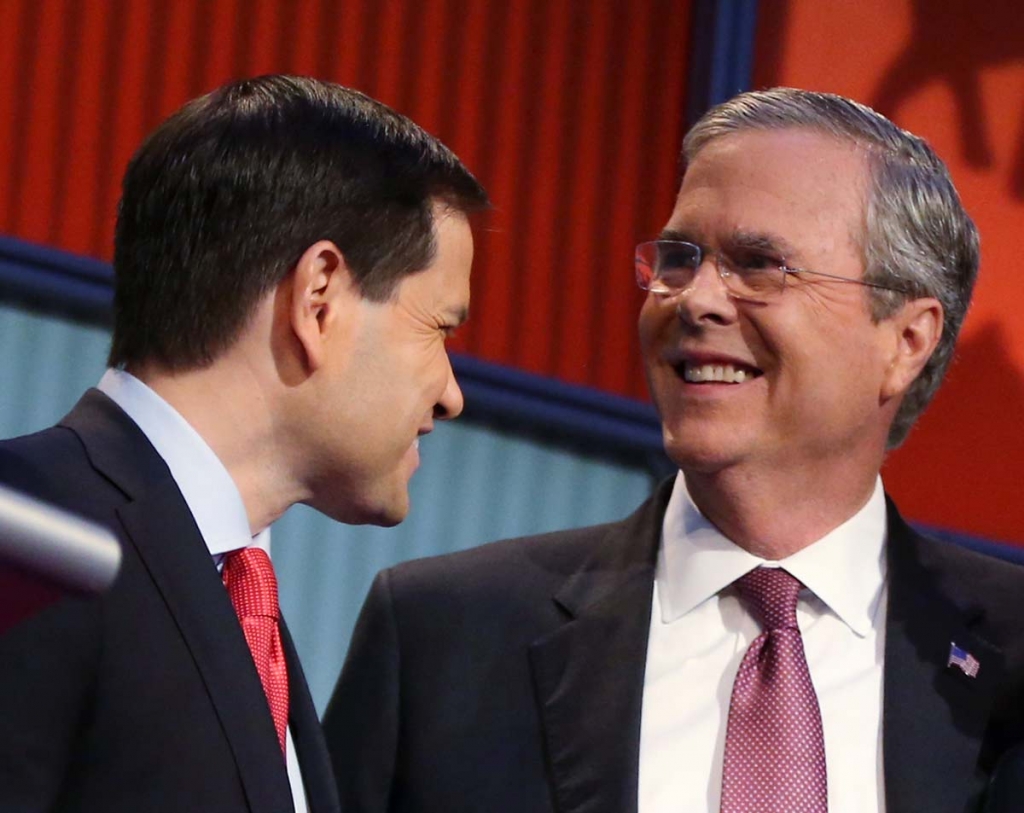 Republican presidential candidates Marco Rubio left and Jeb Bush talk during a break during the first Republican presidential debate at the Quicken Loans Arena in Cleveland