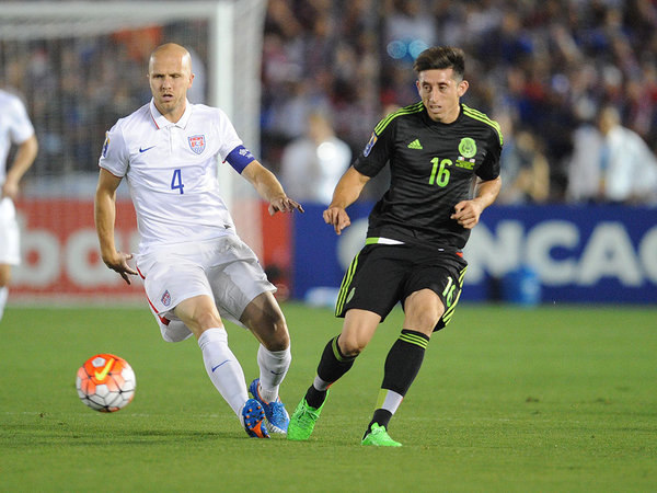 USA midfielder Michael Bradley plays for the ball against Mexico defender Hector Herrera during the first half of the CONCACAF Cup at Rose Bowl