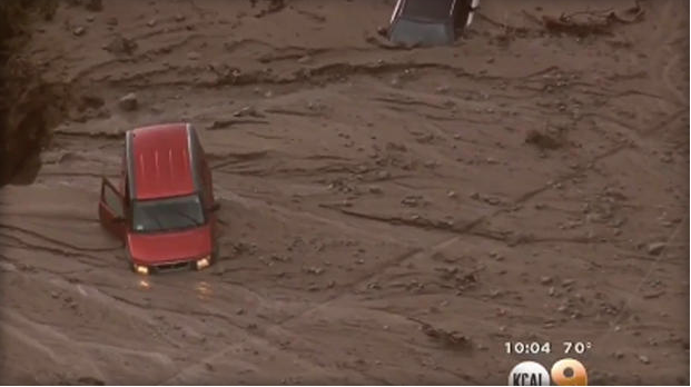 Vehicles are seen stuck and buried in mud after slide that followed torrential rain and hail in Lake Hughes area of California