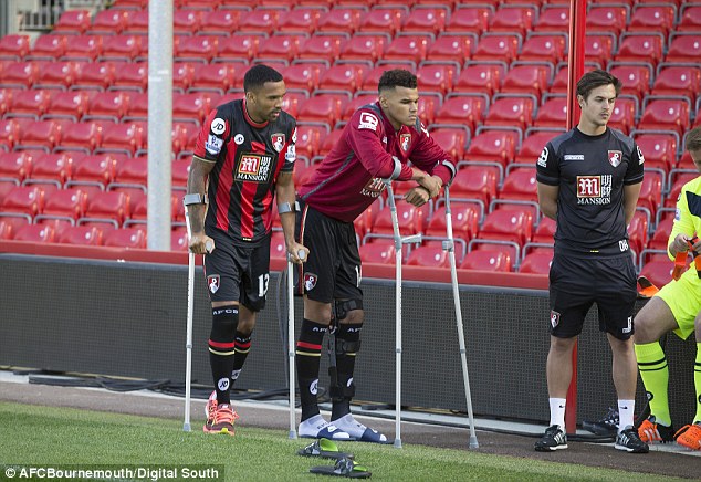 Callum Wilson and Tyrone Mings arrive on crutches ahead of the Bournemouth team