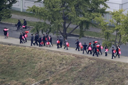 People carrying bouquets of decorative flowers walk towards Kim Il Sung Square Saturday Oct. 10 2015 in Pyongyang North Korea. North Korea is holding what is expected to be one of its biggest celebrations ever Saturday for the 70th anniversary of its