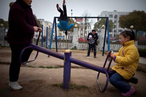 Chinese grandparents and grandchildren play in a park in Dafeng in east China's Jiangsu province. China's ruling Communist Party announced Thursday that it will abolish the country's decades-old one-child policy and allow all couples to