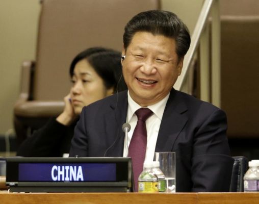 Chinese President Xi Jinping laughs during a meeting