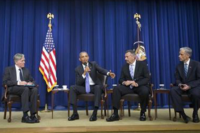 President Barack Obama speaks during a forum on criminal justice reform Thursday Oct. 22 2015 in the Old Executive Office Building on the White House complex in Washington. From left are Bill Keller editor-in-chief Marshall Project Obama Los Ange