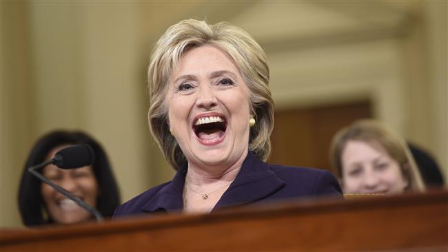 Former US Secretary of State and Democratic presidential candidate Hillary Clinton laughs during testimony before the House Select Committee on Benghazi on Capitol Hill in Washington DC