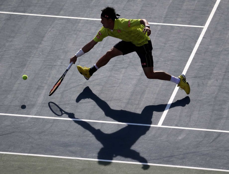 Kei Nishikori of Japan returns a shot against Marin Cilic of Croatia during their singles quarterfinal match at the Japan Open men’s tennis tournament in Tokyo Friday Oct. 9 2015