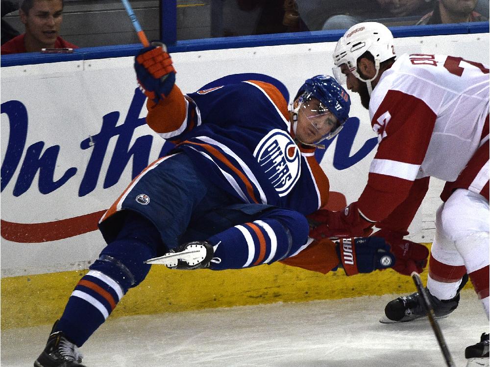 Edmonton Oilers&#039 Nail Yakupov gets upended by Detroit Red Wings&#039 Kyle Quincey during NHL action at Rexall Place on Oct. 22 2015