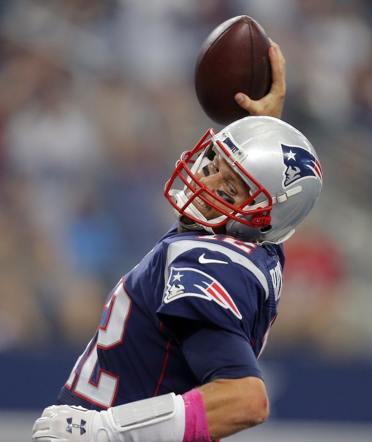 Patriots quarterback Tom Brady celebrates after scoring on a 1-yard run in the first half of Sunday's game against the Cowboys at Arlington Texas