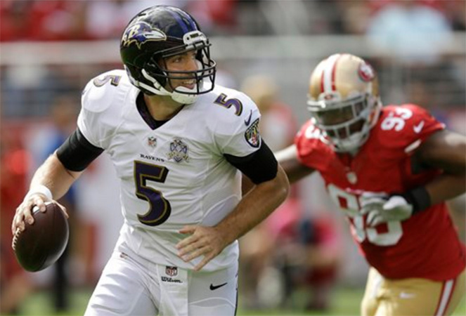 Baltimore Ravens quarterback Joe Flacco scrambles from San Francisco 49ers nose tackle Ian Williams