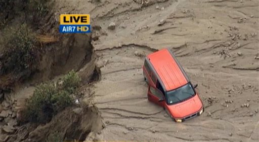 This image taken from video provided by KABC-TV shows a vehicle stuck along a muddy road in the mountainous community of Green Valley Calif. about 65 miles northwest of downtown Los Angeles on Thursday Oct. 15 2015. Flash flooding in northern Los Ang