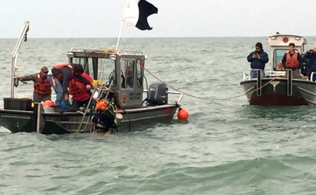 Contractors conduct dive operations at the site of a sunken barge near the Kelley's Island Shoal in Lake Erie Oct. 21 2015