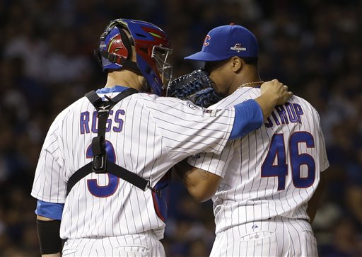 Chicago Cubs catcher David Ross talks to pitcher Pedro Strop during the seventh inning of Game 4 of the National League baseball championship series against the New York Mets Wednesday Oct. 21 2015 in Chicago