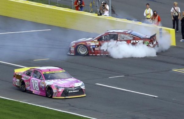 Kyle Busch drives past Kyle Larson