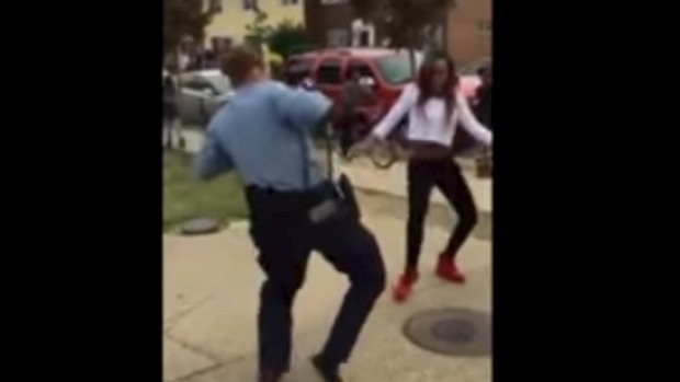 A still from the viral You Tube video showing Aaliyah Taylor dancing with a police officer in Washington DC