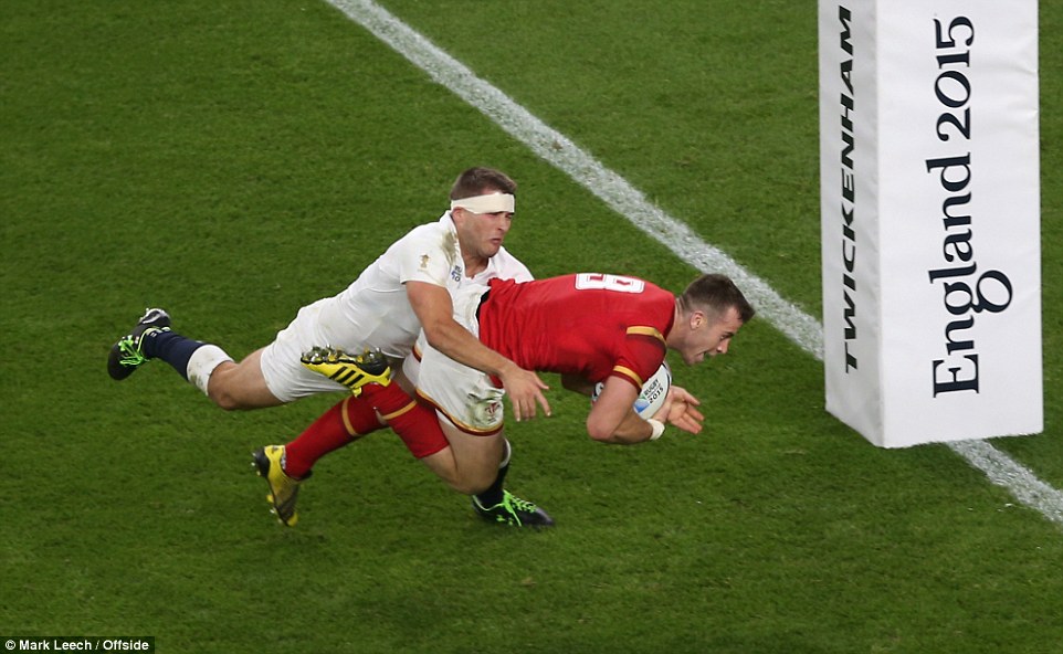Davies gets across the line to score a pivotal try for Wales despite the best efforts from England man Richard Wrigglesworth