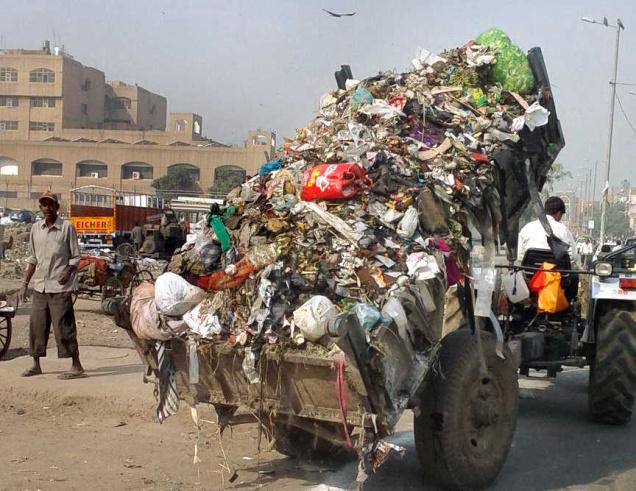 Municipal sanitation workers dump garbage in Shastri Park as a sign of protest on Friday