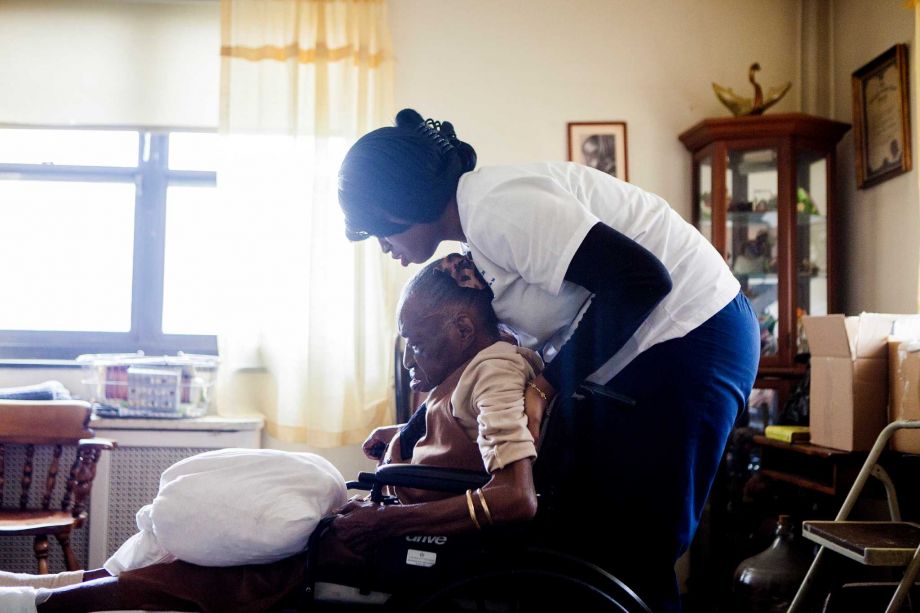 Alicia Joseph a home health aide with Partners in Care assists Naomi Wallace at her home in New York Oct. 24. A group of researchers found that of the three diseases that are the leading killers of Americans- heart disease cancer and dementia- the