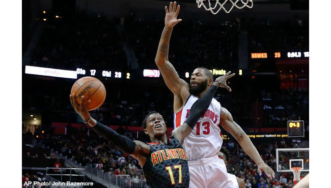 Atlanta Hawks guard Dennis Schroder goes up for a basket as Detroit Pistons forward Marcus Morris defends during the first half of an NBA basketball game Tuesday Oct. 27 2015 in Atlanta