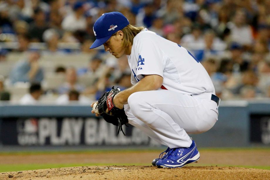 Dodgers starter Zack Greinke pauses during his seven-inning stint that earned him the win in Game 2