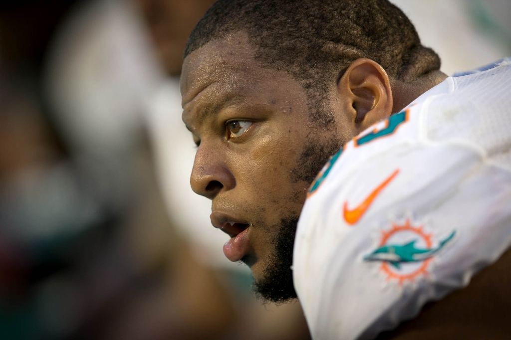 Miami Dolphins defensive tackle Ndamukong Suh sits on the bench in the fourth quarter at Sun Life Stadium in Miami Gardens Florida