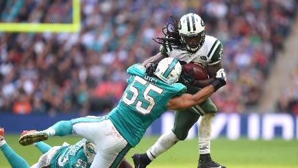 Chris Ivory is tackled by Miami Dolphins&#39 Koa Misi