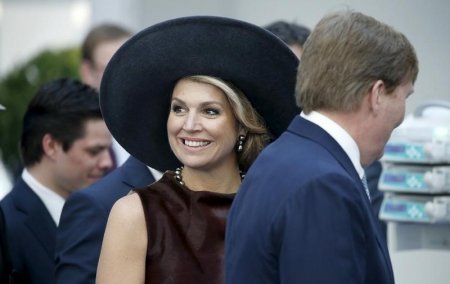 Queen Maxima smiles as she and Dutch King Willem Alexander look at medical equipment at the'Draeger medical facility as part of their visit in the northern German city of Luebeck