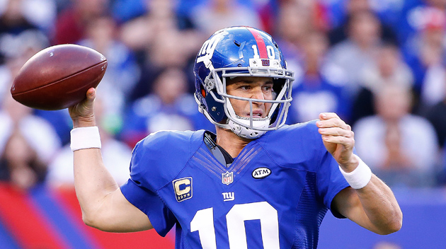 Eli Manning #10 of the New York Giants attempts a pass against the Dallas Cowboys