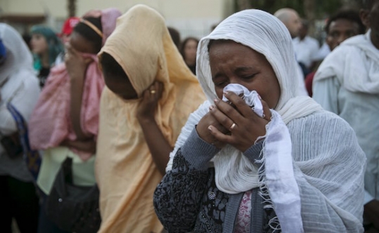 Fellow community members attend a memorial ceremony for Habtom Zarhum an Eritrean migrant who was mistaken for a gunman at a shooting attack earlier in the week in Tel Aviv Israel