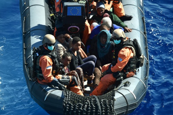 AFP  Alberto Pizzoli Refugees are transported to a German warship- that is helping to capture migrant-smugglers trying to cross the Mediteranean Sea