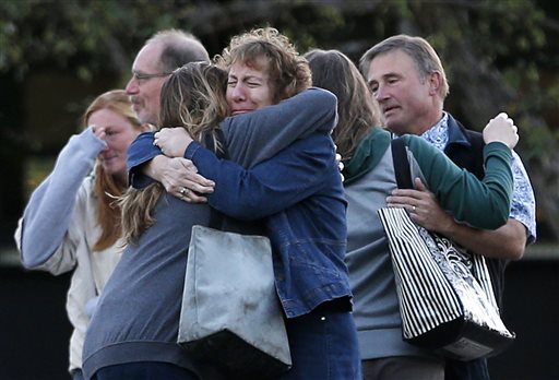 Faculty members embrace as they are allowed to return to Umpqua Community College Monday Oct. 5 2015 in Roseburg Ore. The campus reopened to faculty for the first time since Oct. 1 when armed suspect Chris Harper Mercer killed multiple people and wou
