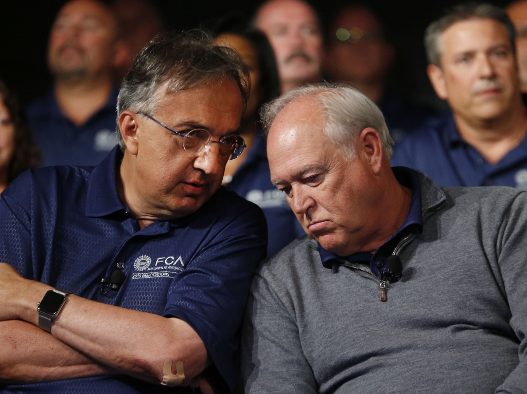 Fiat Chrysler Automobiles CEO Sergio Marchionne and United Auto Workers President Dennis Williams talk back in July.    Paul Sancya    
  AP