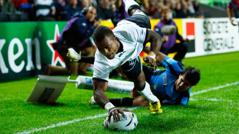 Fiji's Nemia Kenatale holds off Uruguay's Alejo Duran as he scores his side's second try