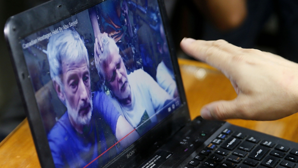 Four people kidnapped by militants from a Philippine resort have begged for help in an online video