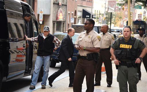 Baltimore city police officers charged in connection with Freddie Gray's death including officer Lt. Brian W. Rice third from left arrive at a side door for a court appearance on Tuesday Oct. 13 2015 in Baltimore. All six officers appeared before