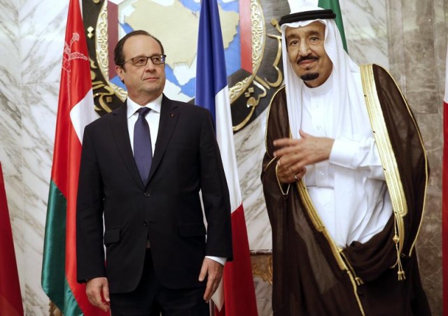 French President Francois Hollande stands beside Saudi Arabias King Salmane ben Abdelaziz Al Saoud during the the Gulf cooperation council summit in Riyadh